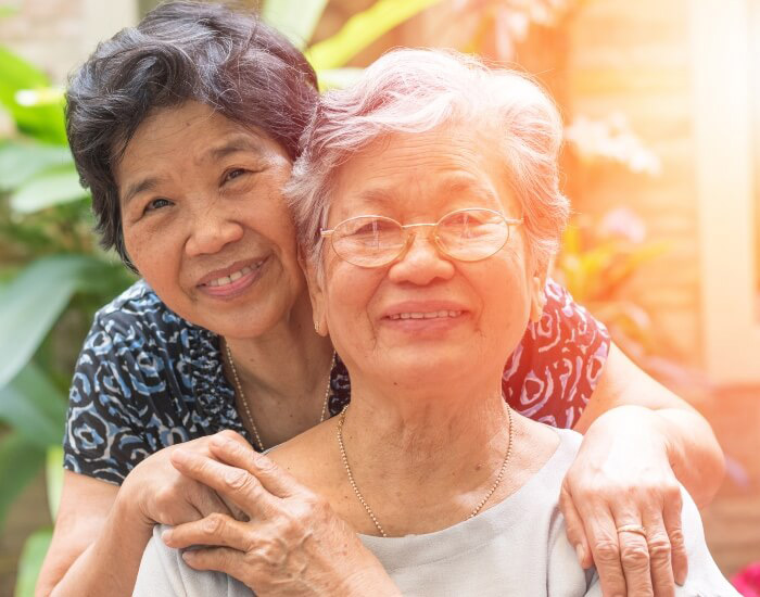 A woman and a hospice patient pose for a photo outside in Torrance, CA.
