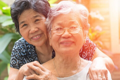 A woman and a hospice patient pose for a photo outside in Torrance, CA.