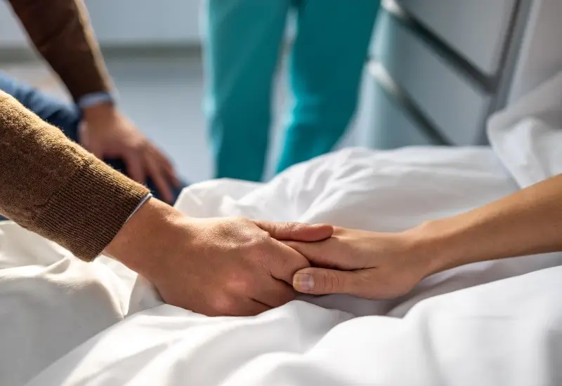 Female patient holding husband's hand