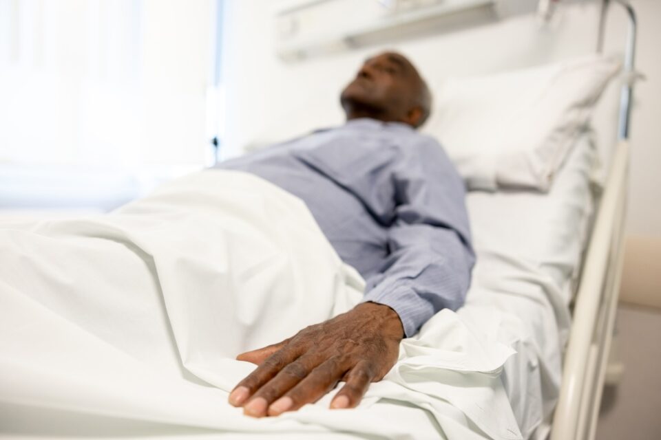 Sick man lying in bed