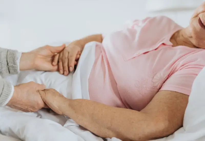 Supportive male holding woman's hands