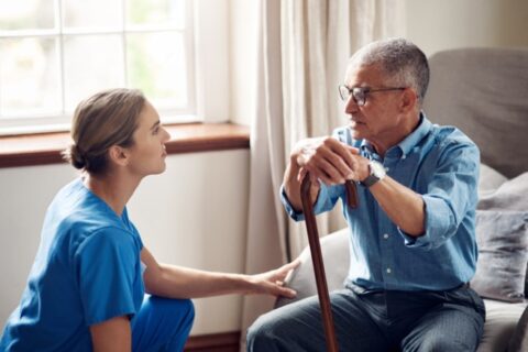 Caregiver speaking with a veteran at home and offering supportive guidance in Orange Counties