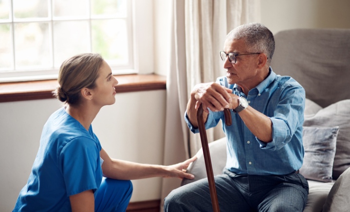 Caregiver speaking with a veteran at home and offering supportive guidance in Orange Counties