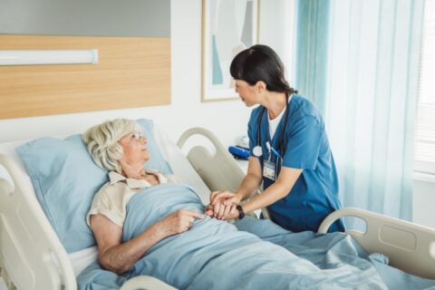 Nurse offering supportive bedside care to a patient in a hospice setting in LA