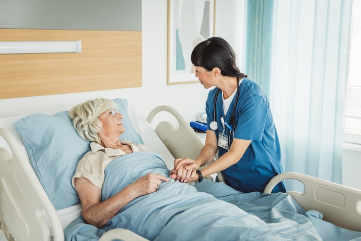 Nurse offering supportive bedside care to a patient in a hospice setting in LA
