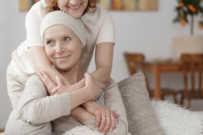 A caregiver giving comforting support to a patient during hospice care at home in Orange Counties