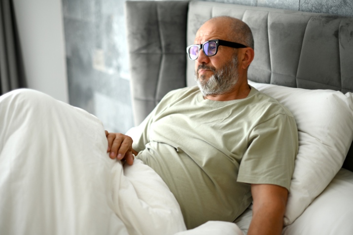 Patient sitting up in bed at home during hospice care in LA