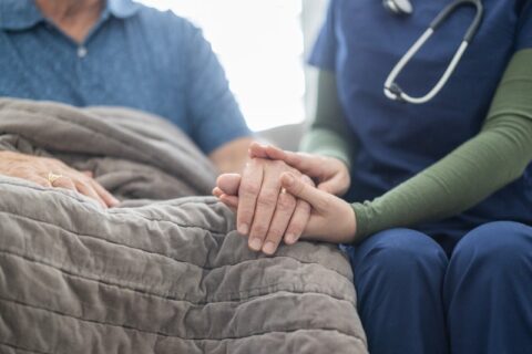 Hospice care provider holding a patient’s hand to offer support in Los Angeles & Orange Counties